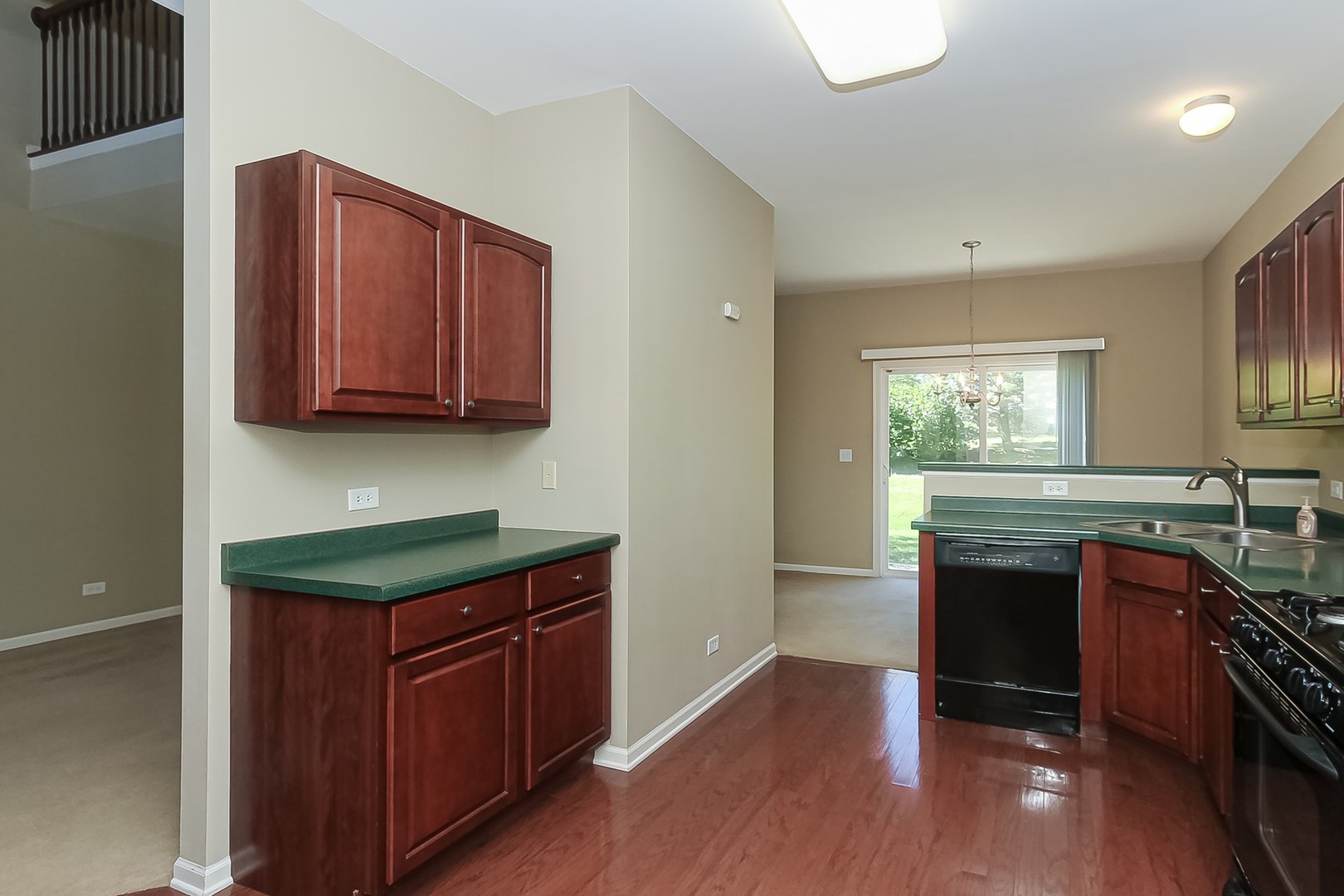 112 Durango Drive Gilberts, IL 60136 - Photo 11 of 24 a kitchen with stainless steel appliances granite countertop a stove and a sink