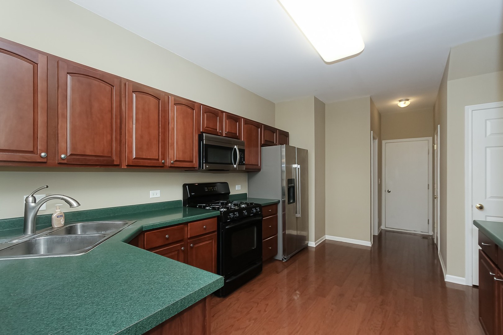 112 Durango Drive Gilberts, IL 60136 - Photo 8 of 24 a kitchen with stainless steel appliances granite countertop a sink stove and refrigerator