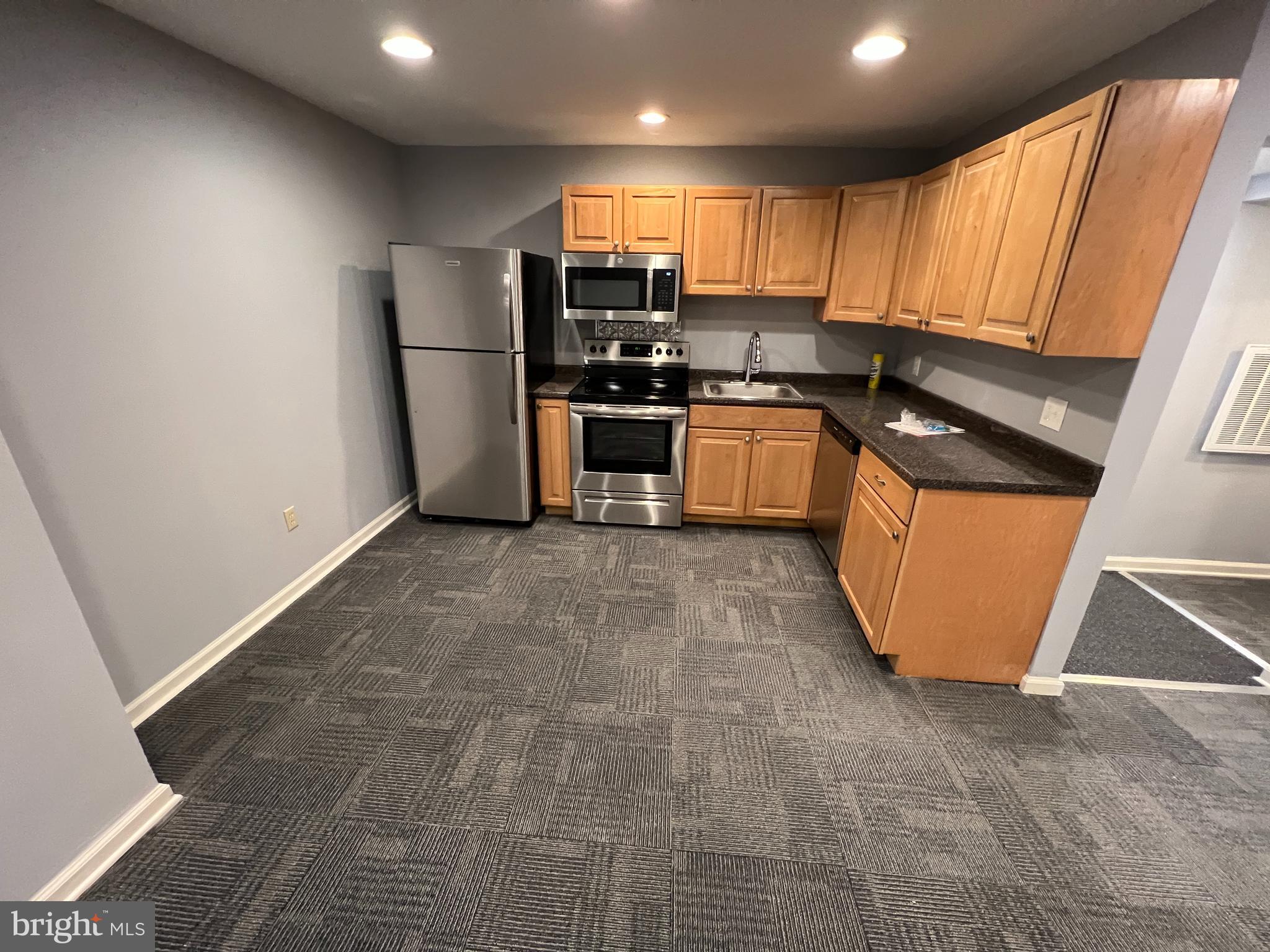44 East Court Street Doylestown, PA 18901 - Photo 2 of 9 a kitchen with granite countertop a refrigerator and a sink