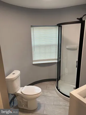 a bathroom with a toilet and a shower
