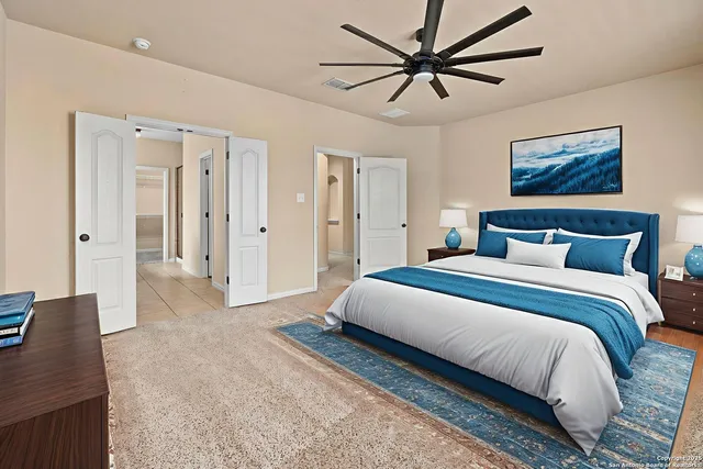 a bedroom with a bed and a chandelier