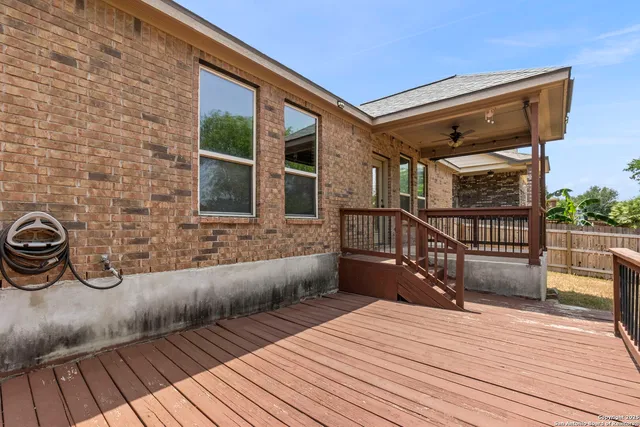 a view of a deck with wooden floor and iron stairs