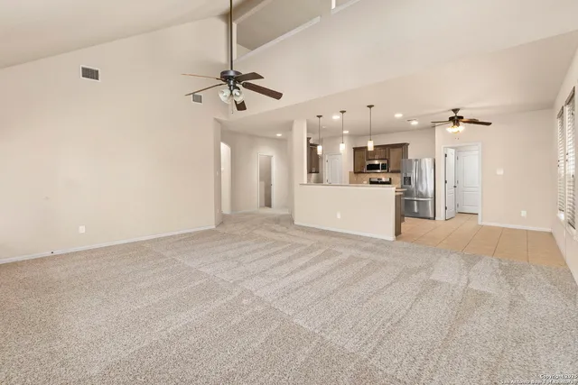 a view of a kitchen with a sink and a refrigerator