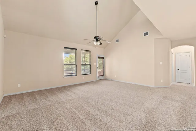 a view of a livingroom with a ceiling fan and window