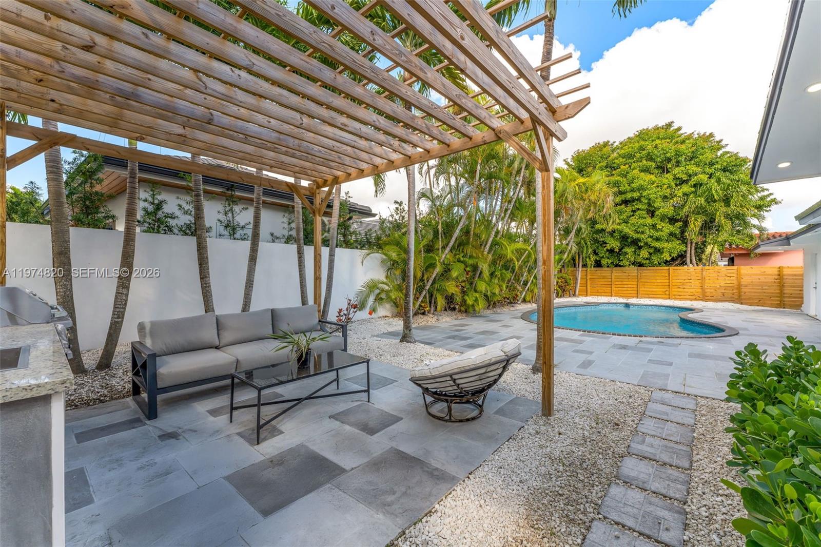 7120 Southwest 92nd Avenue Miami, FL 33173 - Photo 11 of 48 a living room with patio furniture and a potted plant