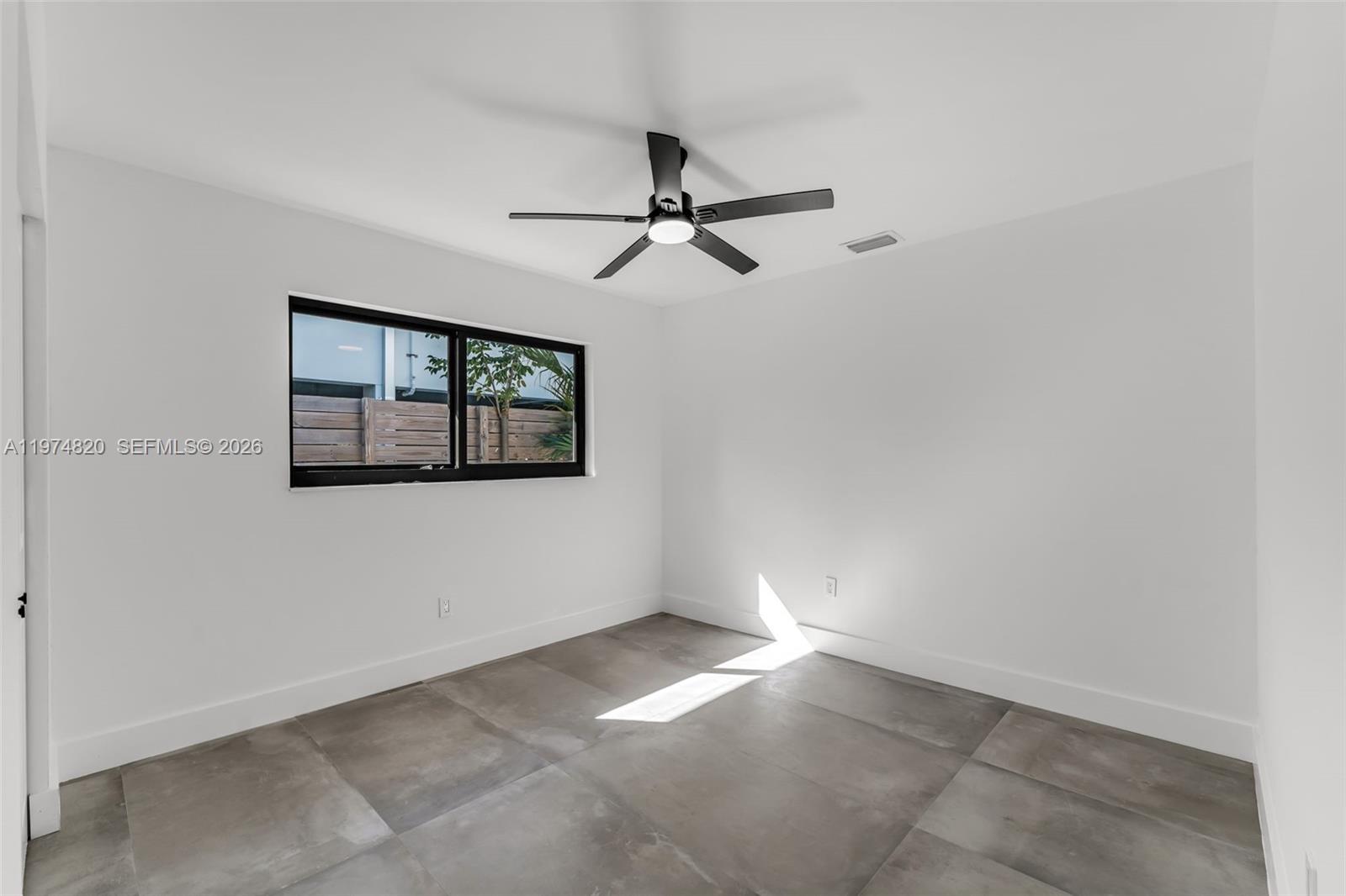 7120 Southwest 92nd Avenue Miami, FL 33173 - Photo 20 of 48 an empty room with windows and fan