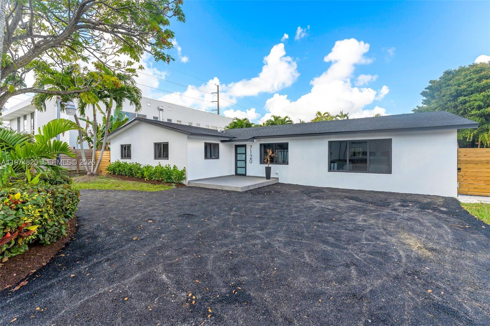7120 Southwest 92nd Avenue Miami, FL 33173 - Photo 2 of 48 a view of a house with a yard and potted plants
