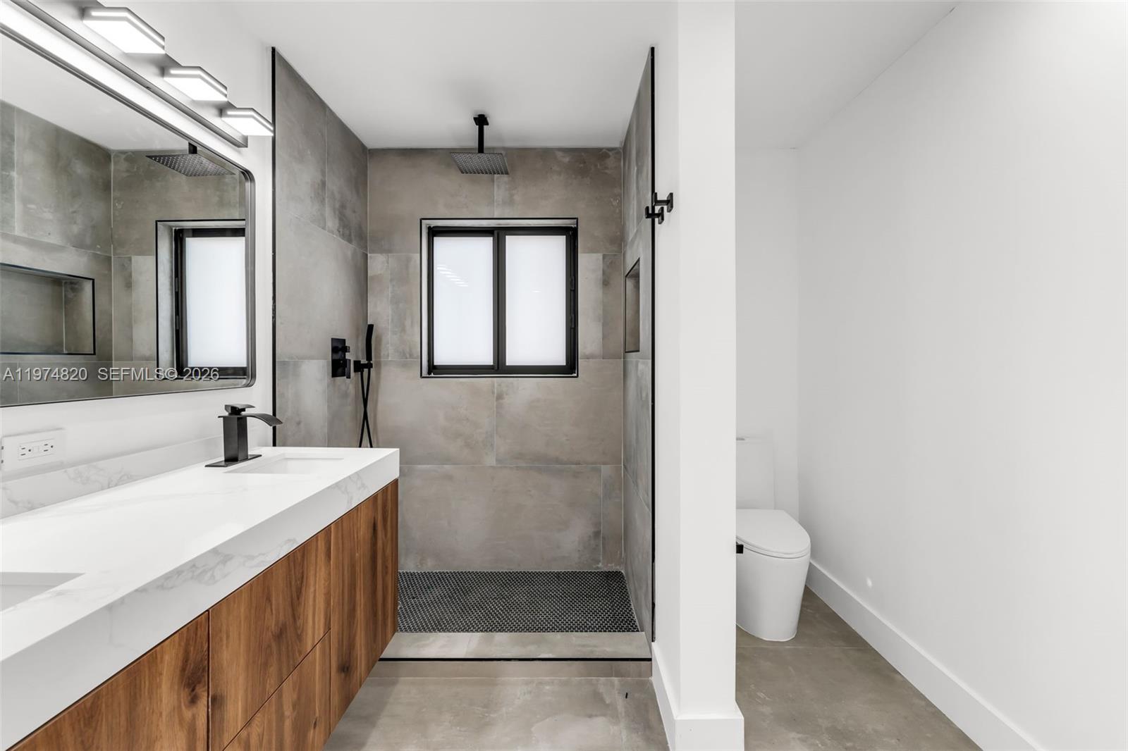 7120 Southwest 92nd Avenue Miami, FL 33173 - Photo 23 of 48 a bathroom with a sink a toilet and shower