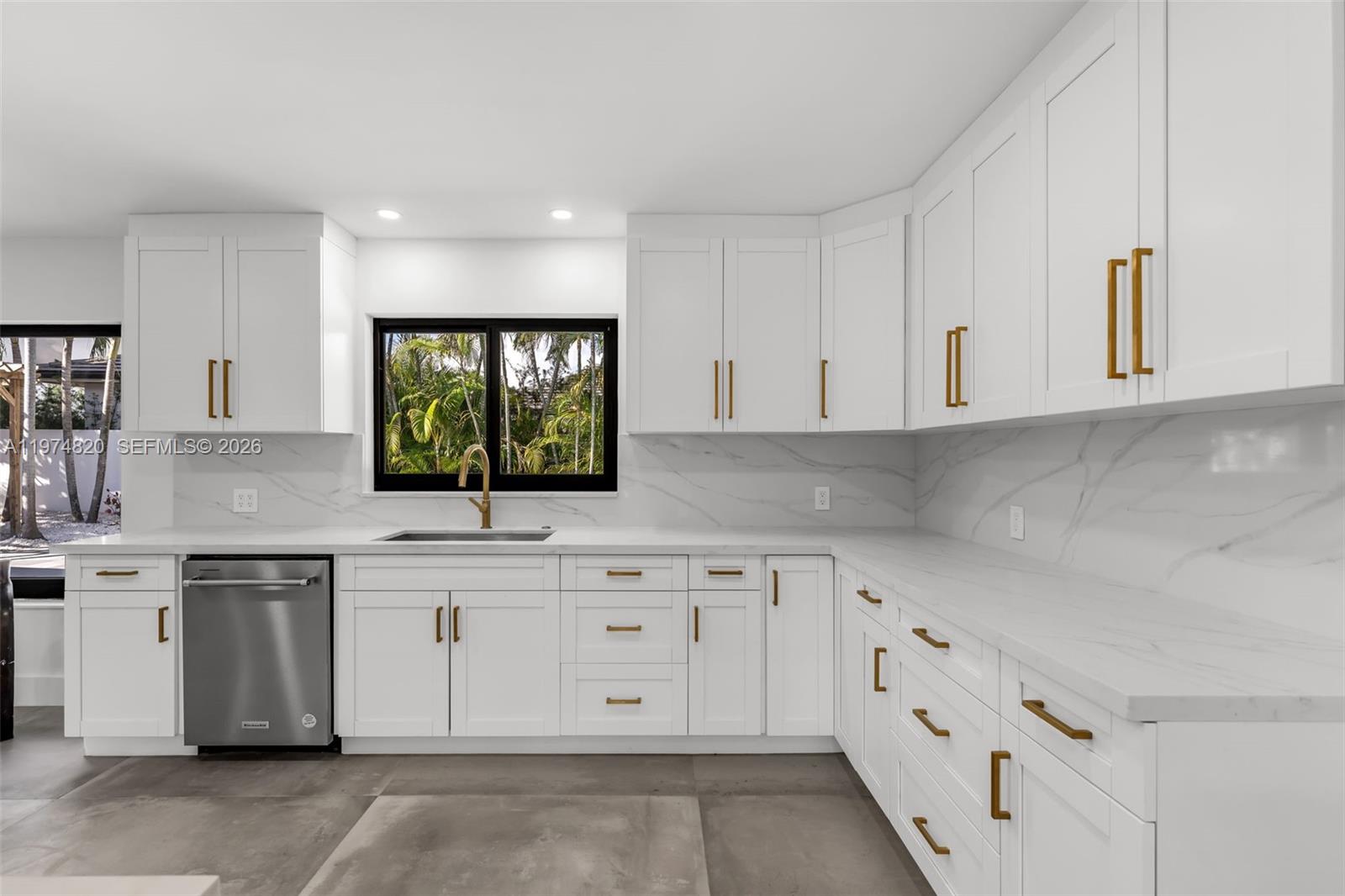 7120 Southwest 92nd Avenue Miami, FL 33173 - Photo 29 of 48 a kitchen with white cabinets appliances a sink and a window