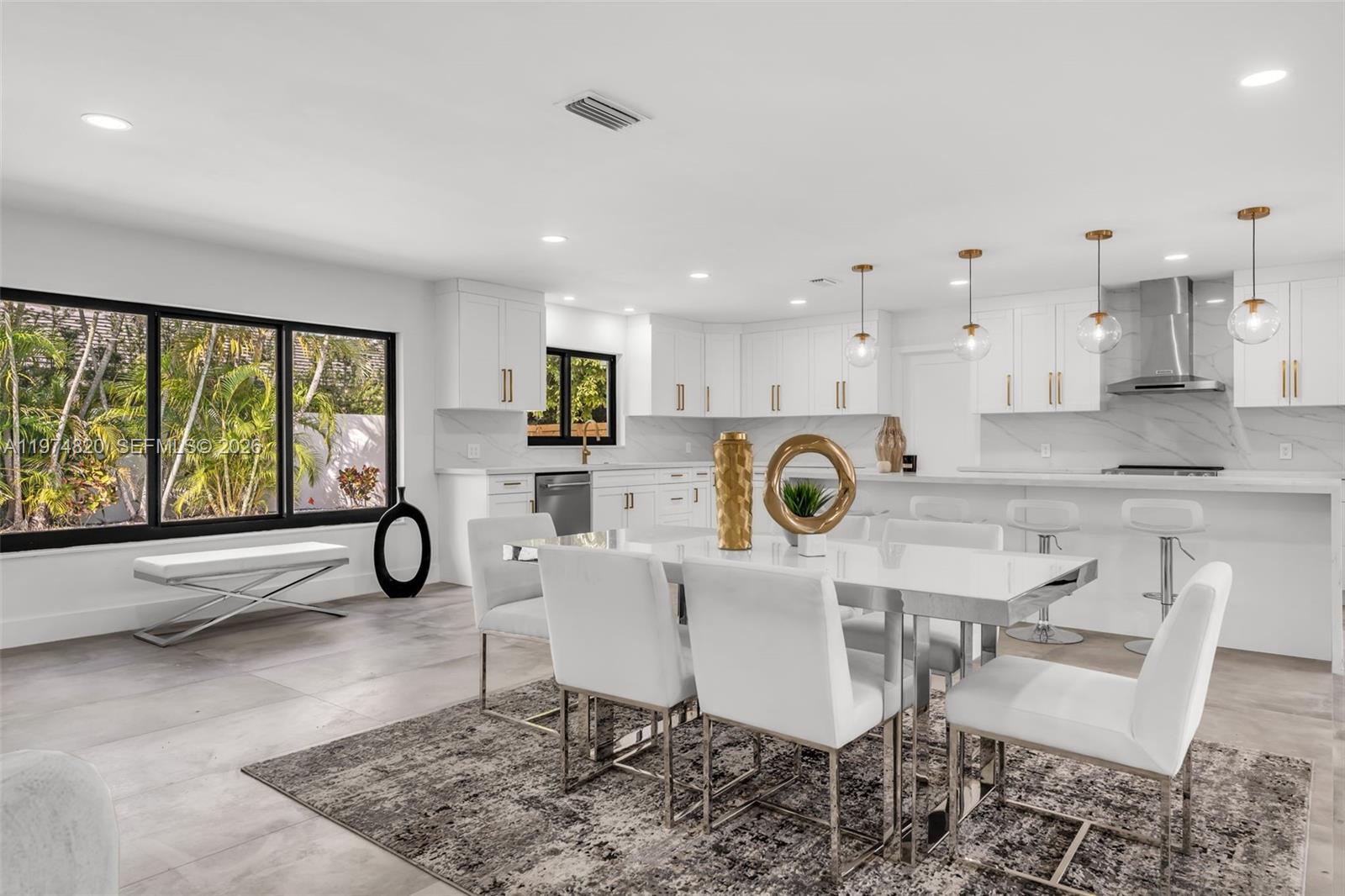 7120 Southwest 92nd Avenue Miami, FL 33173 - Photo 31 of 48 a kitchen with a dining table chairs and refrigerator