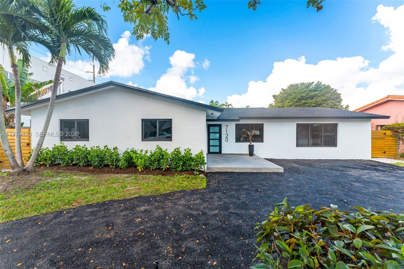 7120 Southwest 92nd Avenue Miami, FL 33173 - Photo 39 of 48 a front view of a house with a garden