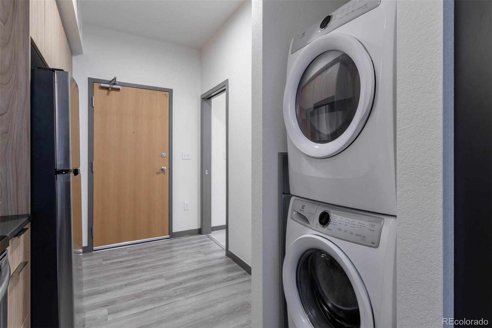 603 Inca Street, Unit 216 Denver, CO 80204 - Photo 17 of 22 a view of a hallway with washer and dryer