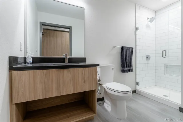 a bathroom with a toilet a sink and shower