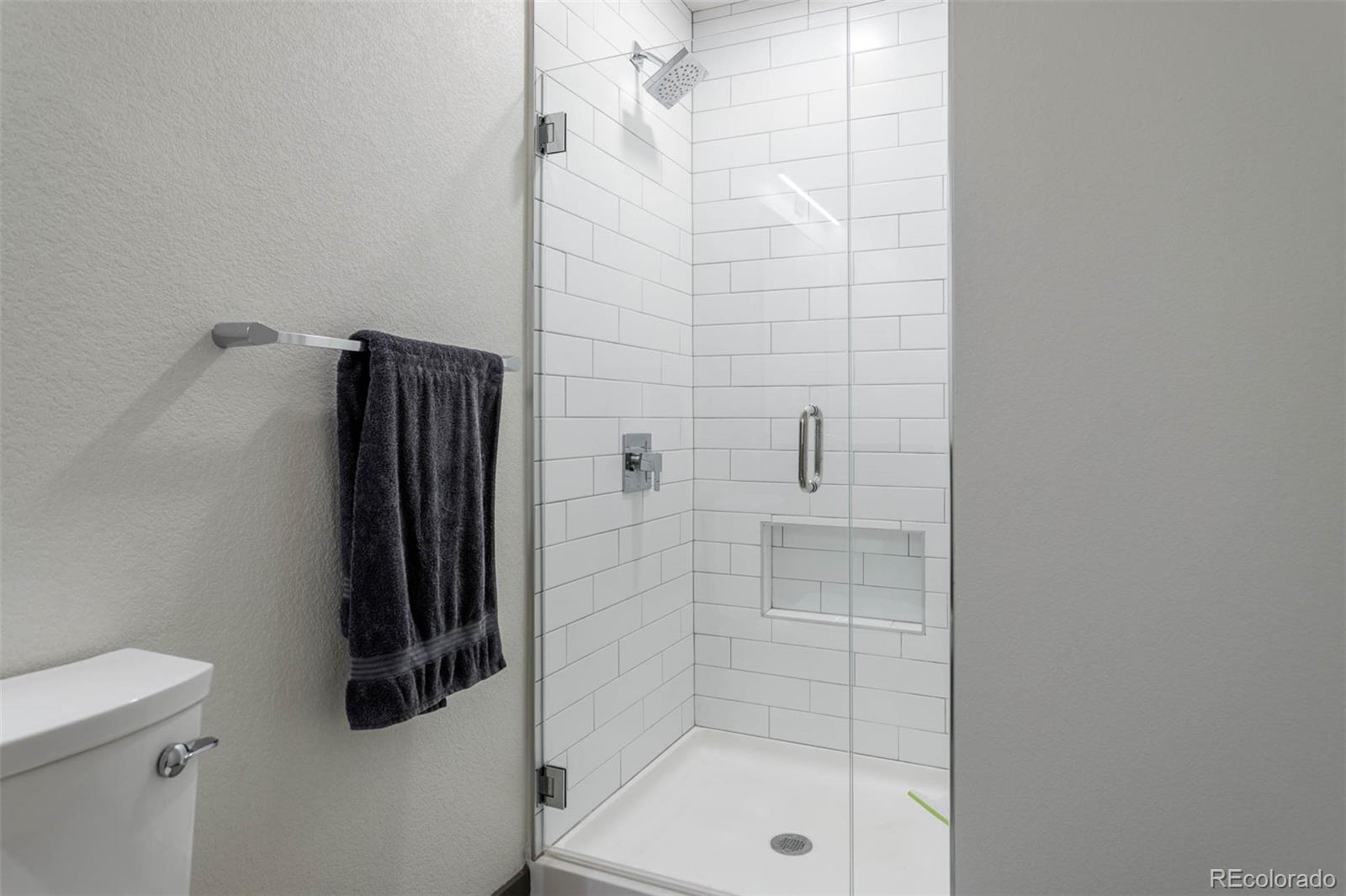 603 Inca Street, Unit 216 Denver, CO 80204 - Photo 19 of 22 a bathroom with a shower and toilet