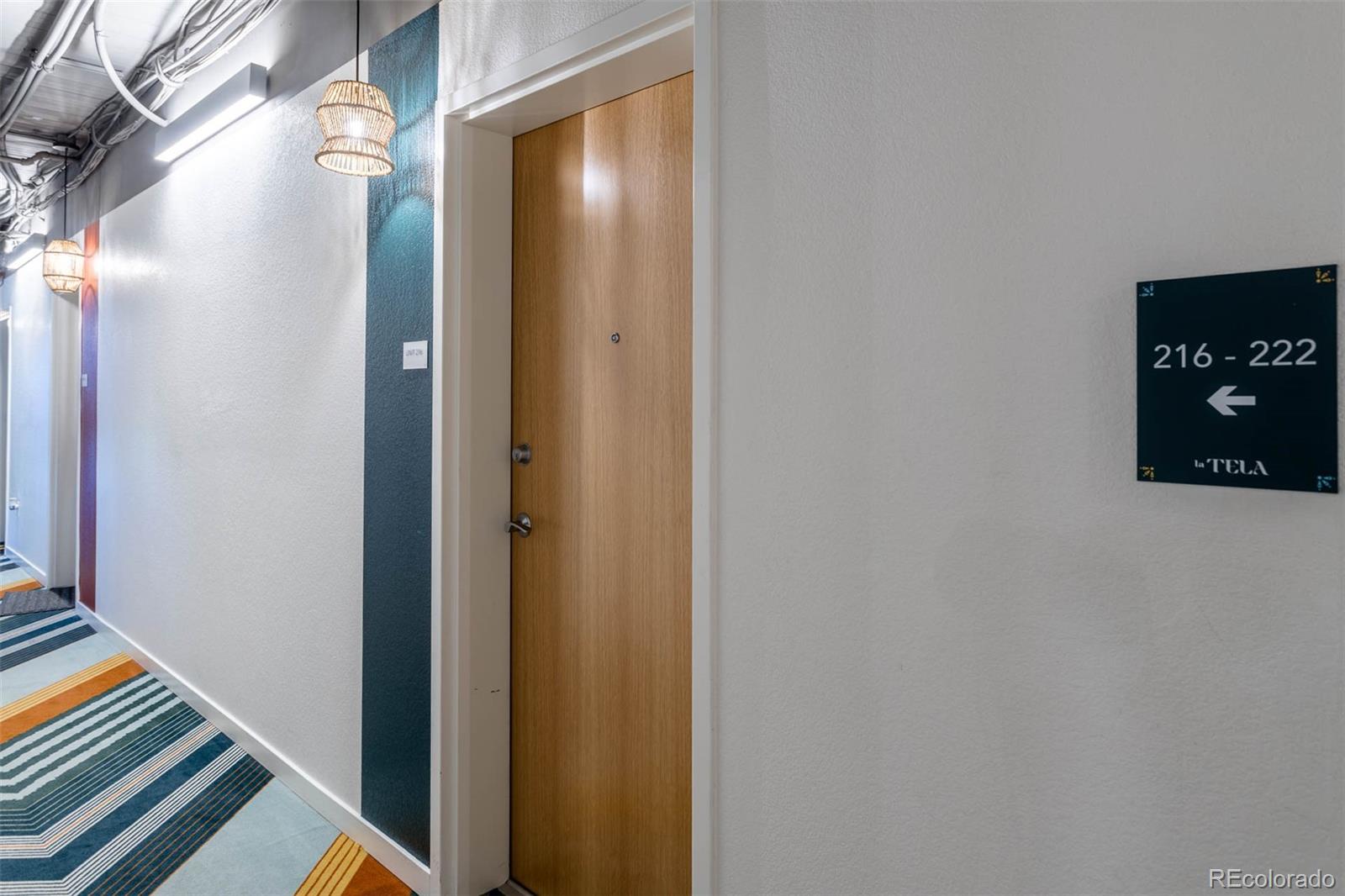 603 Inca Street, Unit 216 Denver, CO 80204 - Photo 7 of 22 a door with a hallway