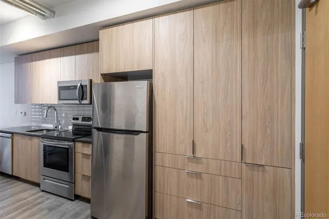 a white refrigerator freezer sitting in a kitchen