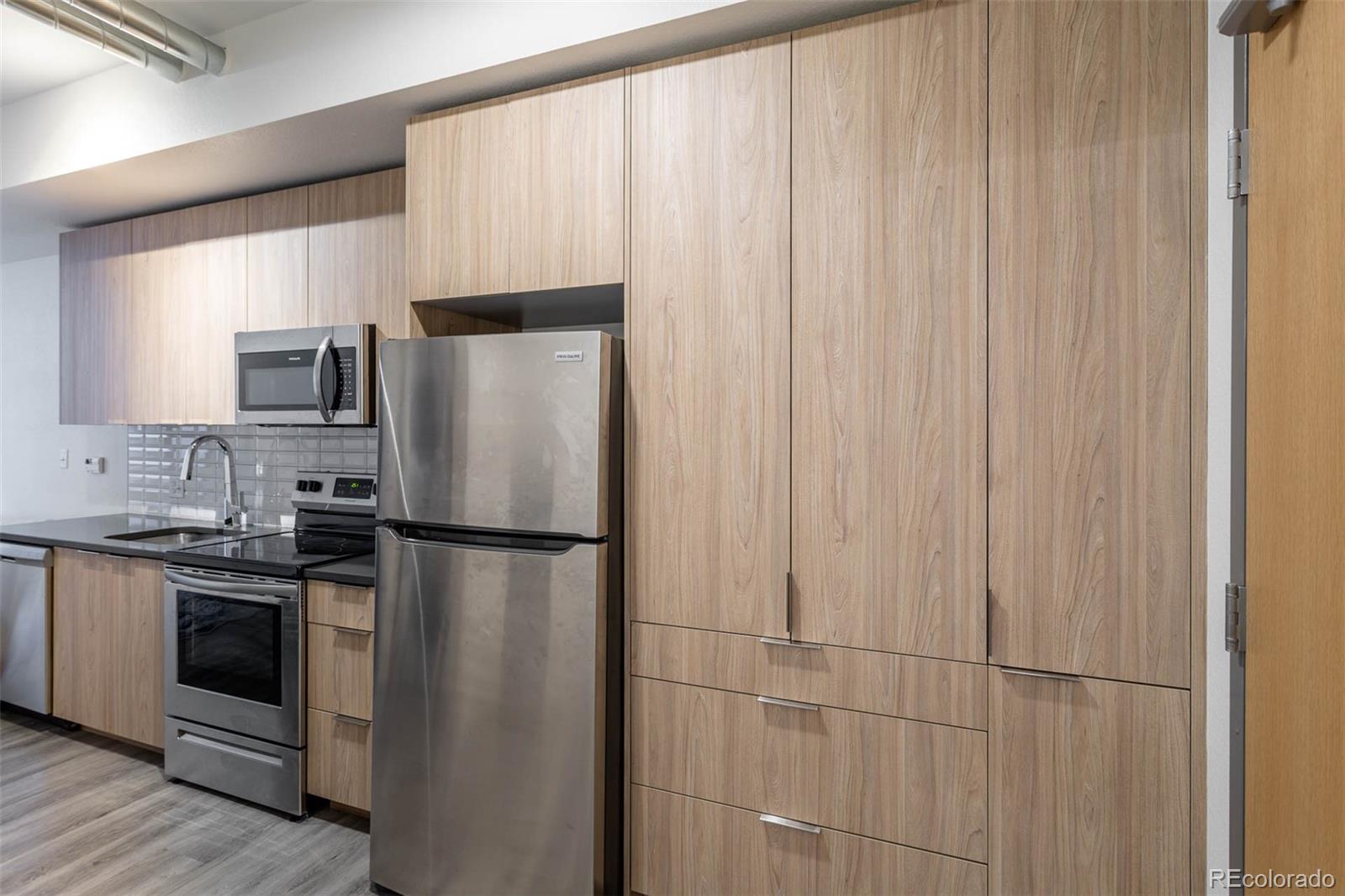 603 Inca Street, Unit 216 Denver, CO 80204 - Photo 8 of 22 a white refrigerator freezer sitting in a kitchen