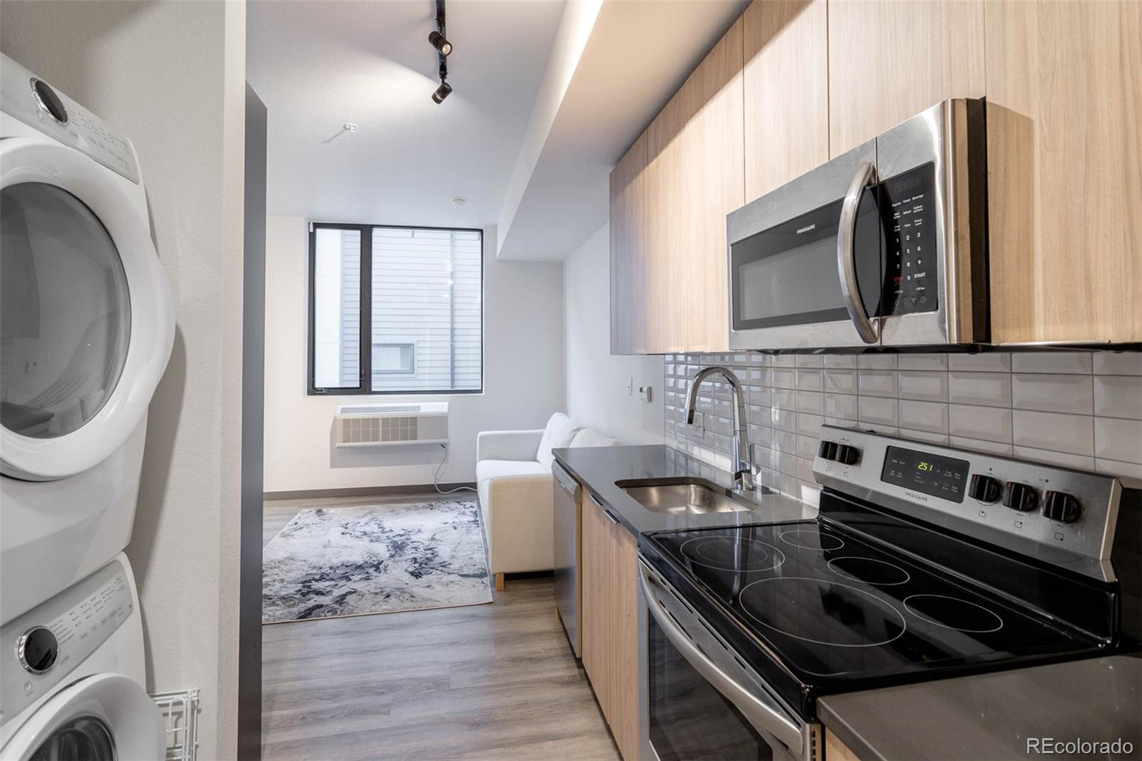 603 Inca Street, Unit 216 Denver, CO 80204 - Photo 10 of 22 a kitchen with stainless steel appliances a stove a sink and a microwave