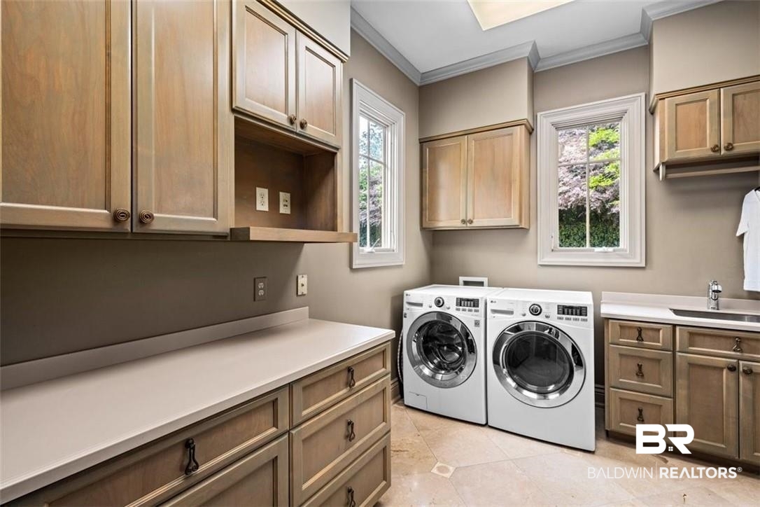 4 Chancery Court Mobile, AL 36608 - Photo 53 of 54 Washroom featuring cabinets, washing machine and dryer, crown molding, and sink