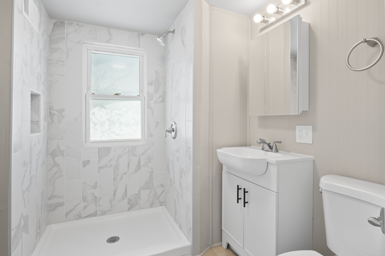 5604 South Madison Avenue Countryside, IL 60525 - Photo 15 of 29 a bathroom with a sink a toilet and shower