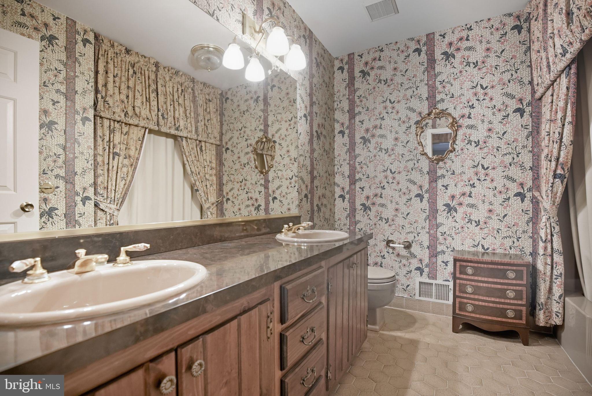 14 Devon Drive New Hope, PA 18938 - Photo 21 of 40 a bathroom with a granite countertop sink a mirror and a shower