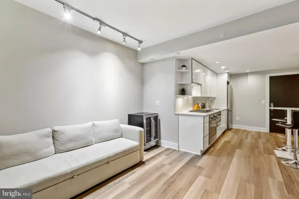 a living room with kitchen island furniture and a wooden floor