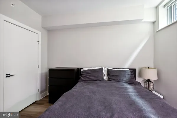 a bedroom with a bed and cabinets