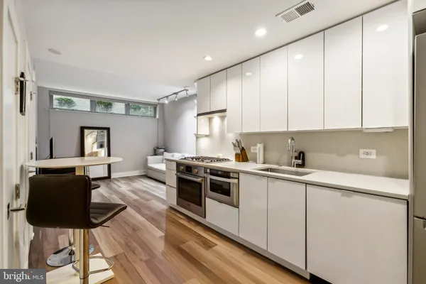 a kitchen with a stove and white cabinets