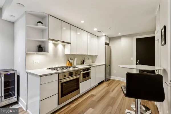 a kitchen with a stove a sink and a refrigerator