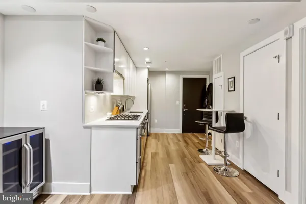 a kitchen with stainless steel appliances kitchen island granite countertop a refrigerator and a stove top oven