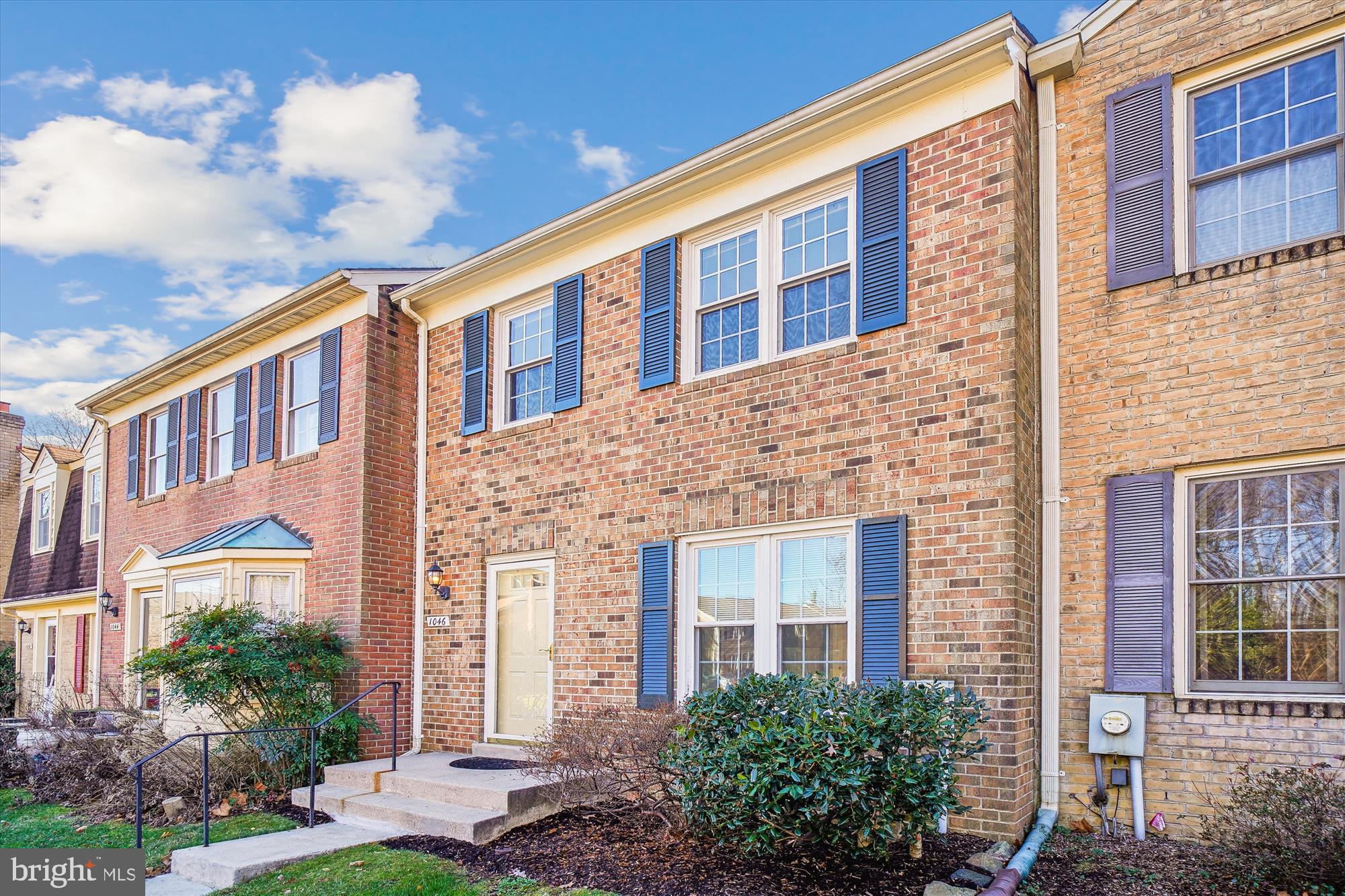 1046 Windrush Lane, Unit 38 Sandy Spring, MD 20860 - Photo 44 of 63 a view of a building next to a yard