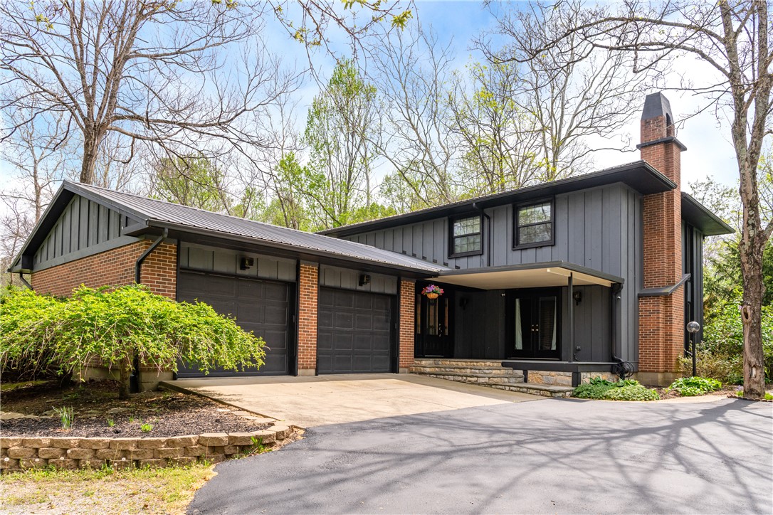 6750 Little Twin Road Germantown, OH 45327 - Photo 2 of 88 This residence features a striking facade with a metal roof and an attached garage.