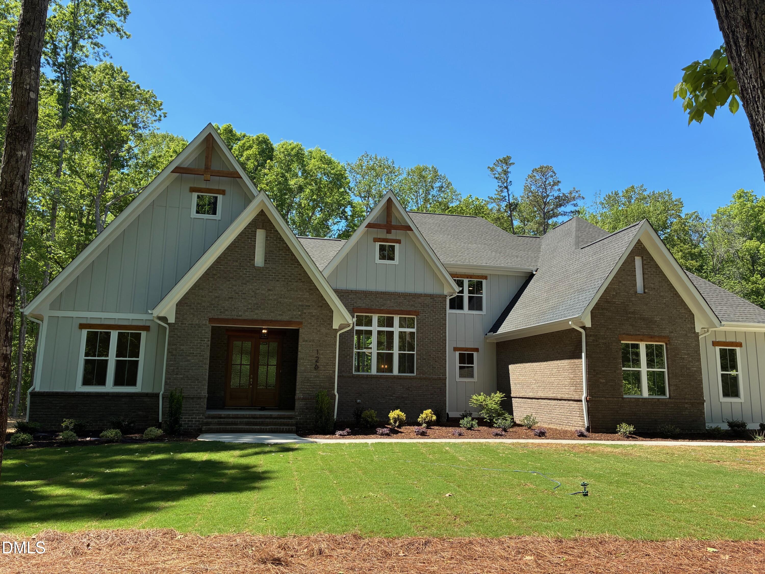 638 Old Goldston Road Pittsboro, NC 27312 - Photo 10 of 28 a front view of a house with a yard and garage