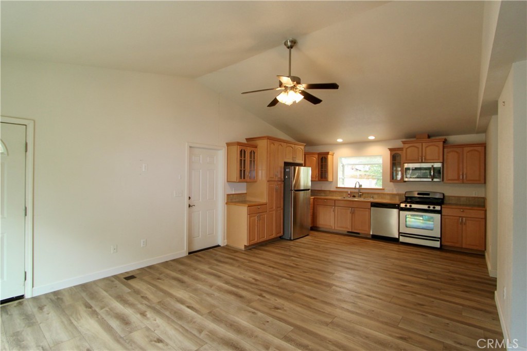 3085 Gardner Road Nice, CA 95464 - Photo 4 of 20 a large kitchen with cabinets wooden floor and stainless steel appliances
