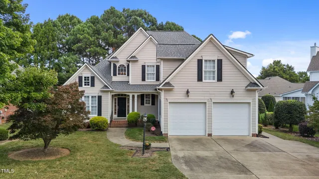 a front view of a house with a yard garage and outdoor seating