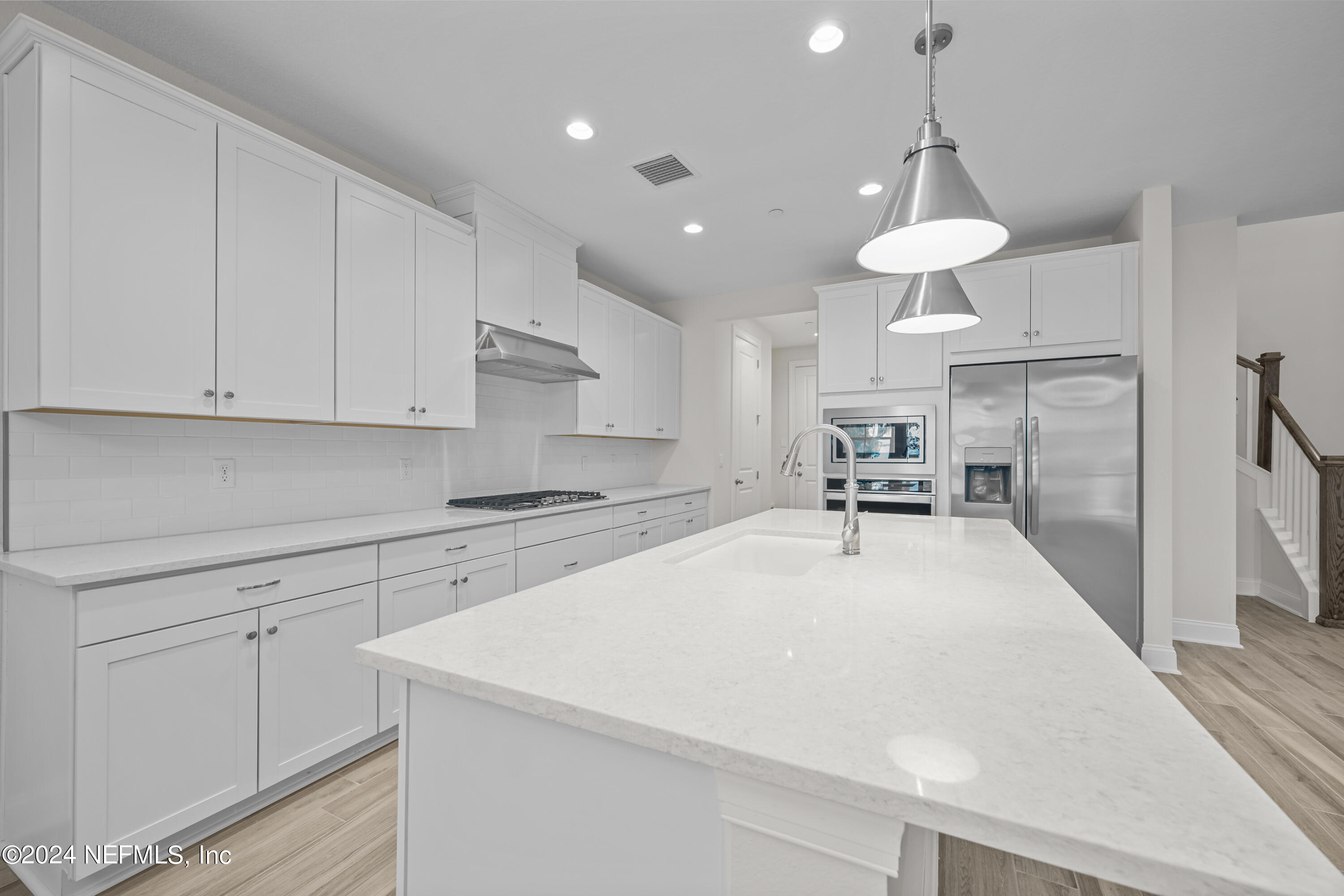 23 Oak Pk Drive St. Johns, FL 32259 - Photo 15 of 72 a large white kitchen with wooden floor and a sink