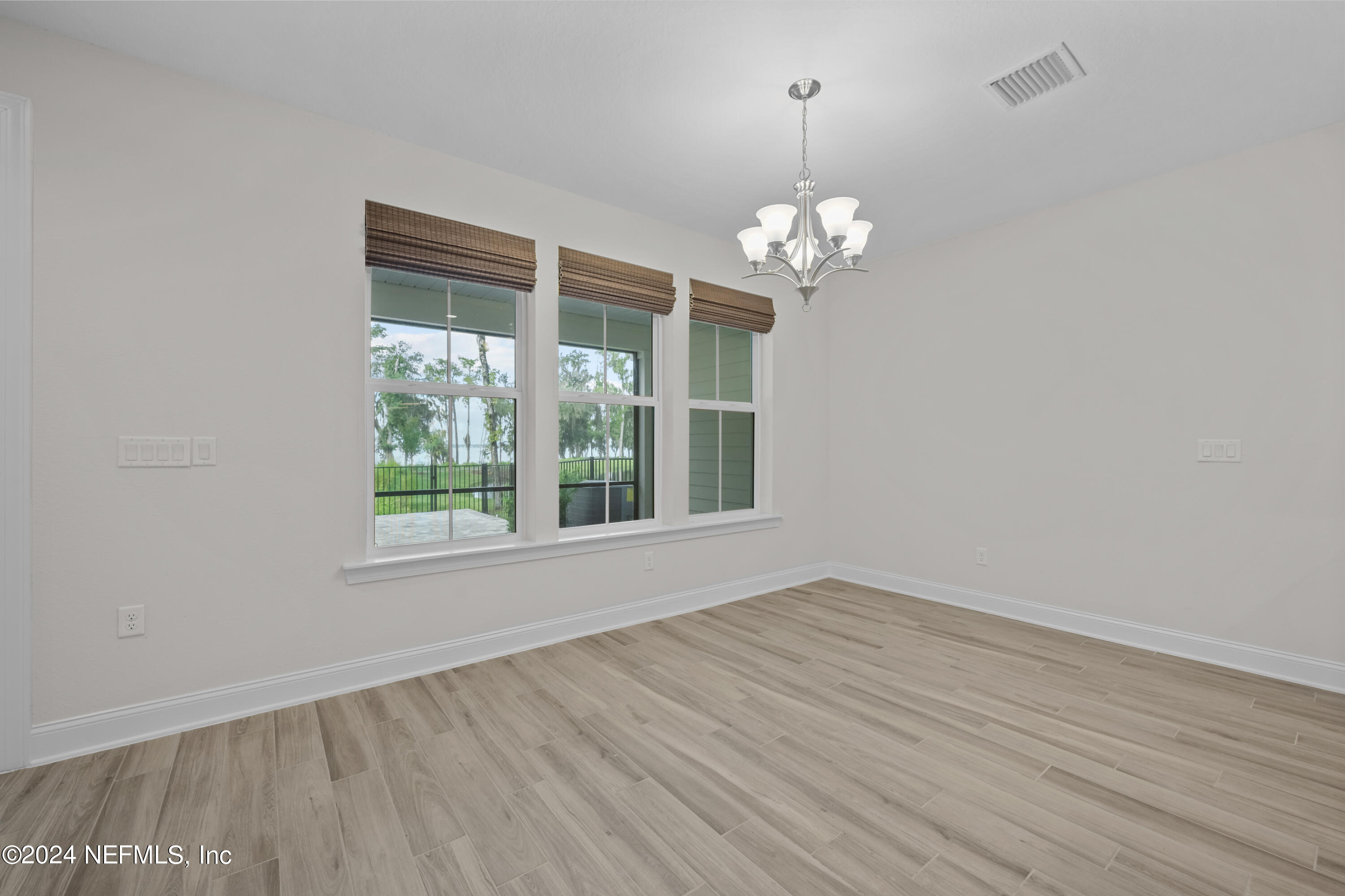 23 Oak Pk Drive St. Johns, FL 32259 - Photo 20 of 72 wooden floor in an empty room with a window