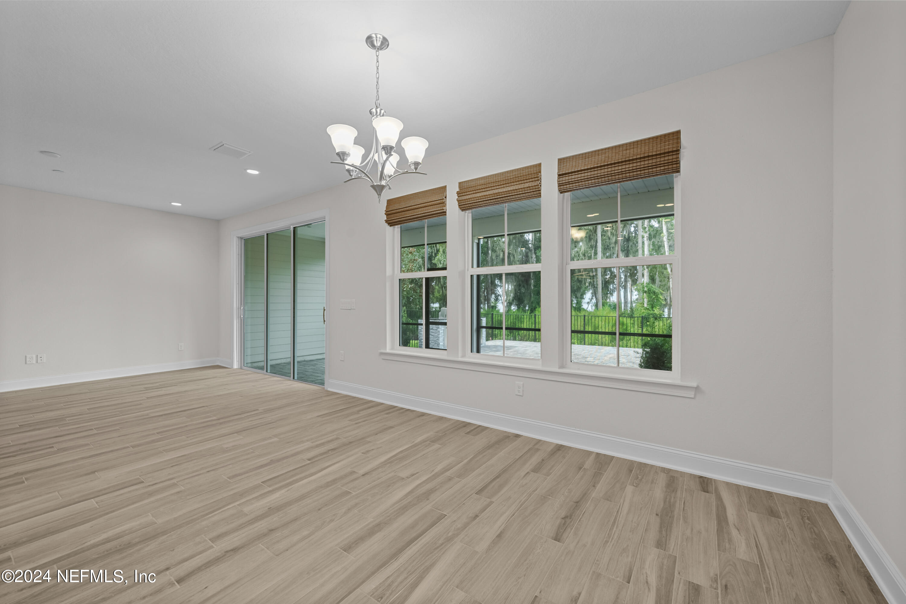 23 Oak Pk Drive St. Johns, FL 32259 - Photo 21 of 72 a view of an empty room with wooden floor and a window