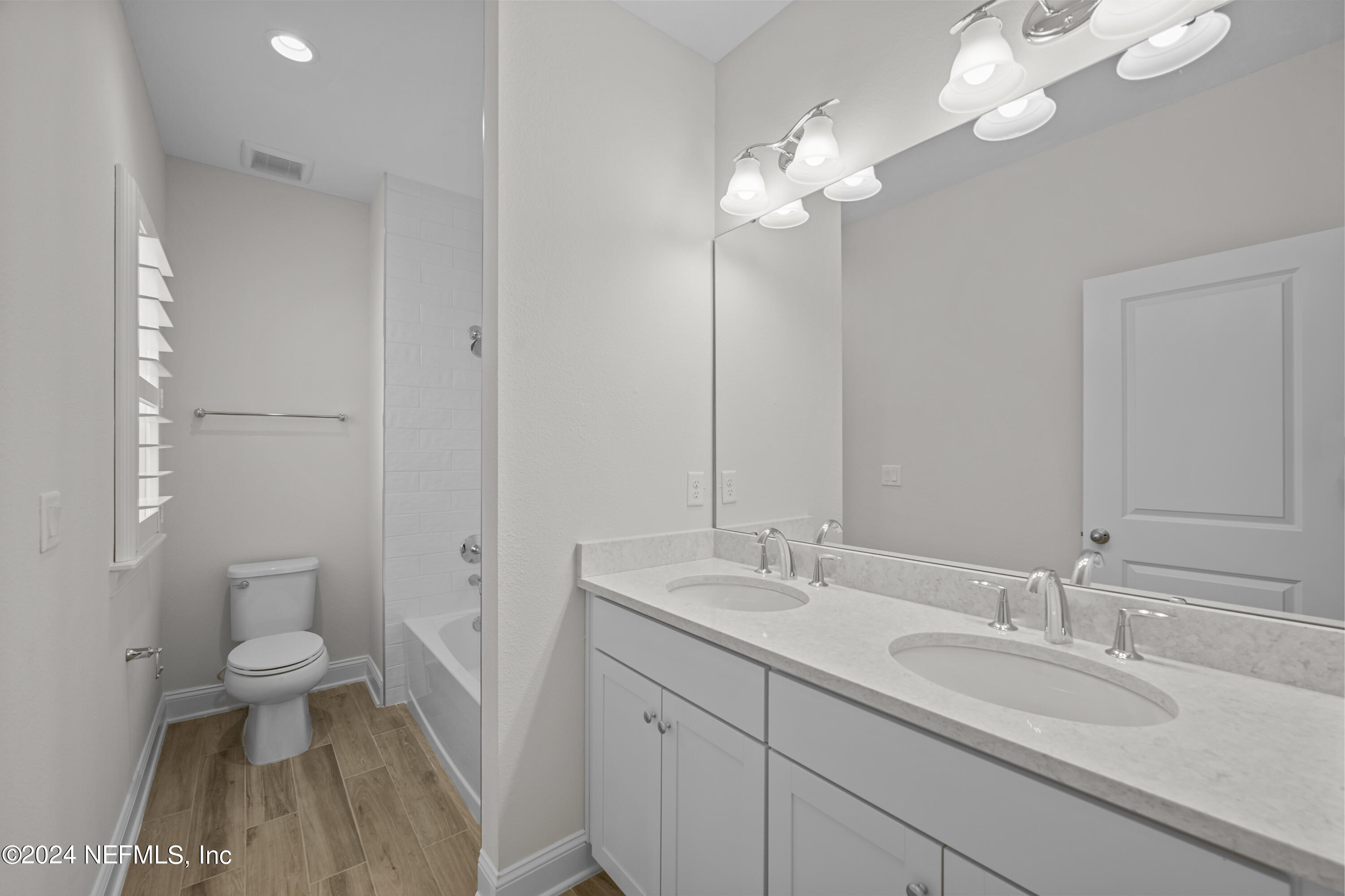 23 Oak Pk Drive St. Johns, FL 32259 - Photo 38 of 72 a bathroom with a sink a toilet and a large mirror