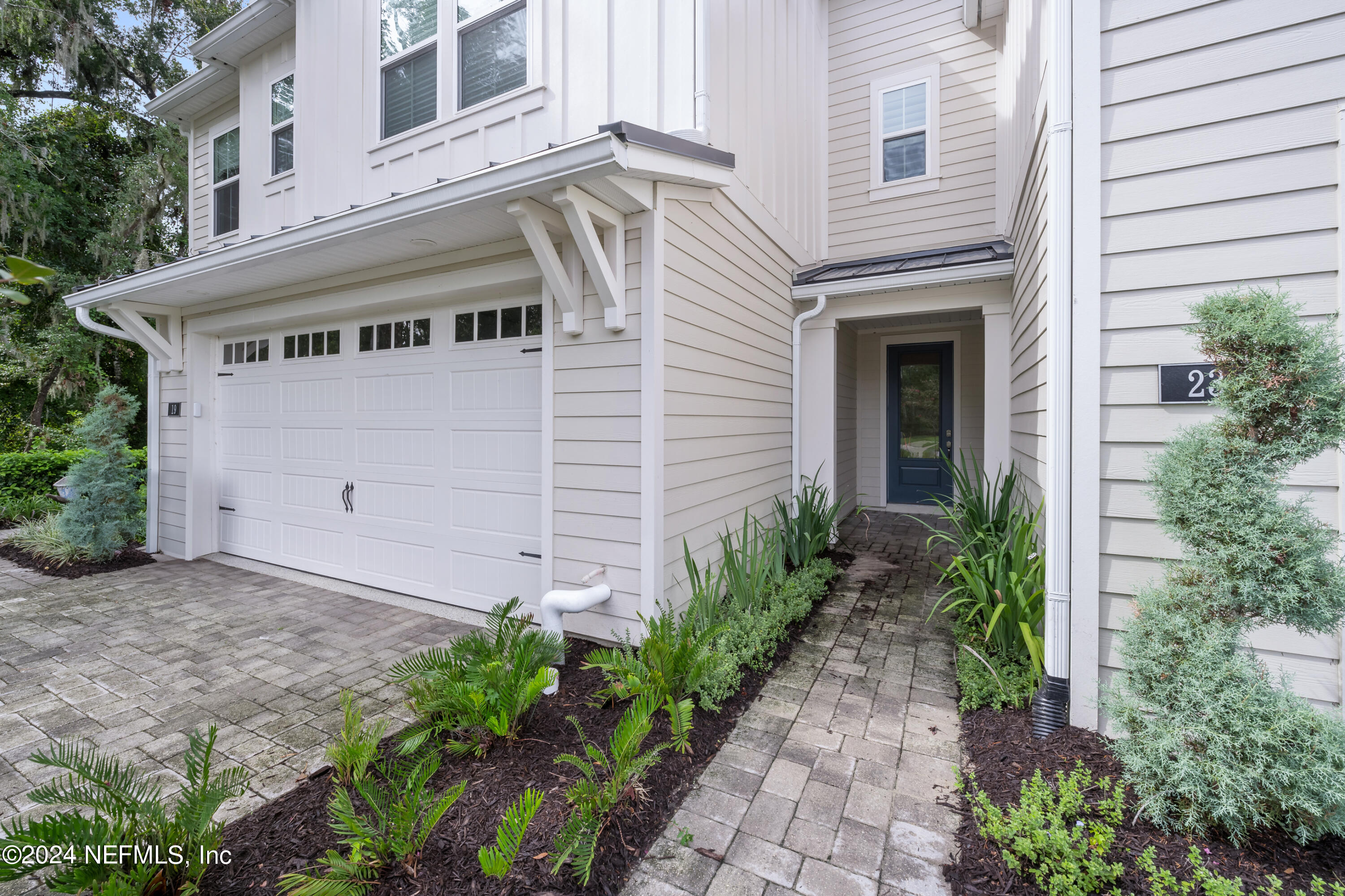 23 Oak Pk Drive St. Johns, FL 32259 - Photo 4 of 72 a view of a house with potted plants and a table and chairs