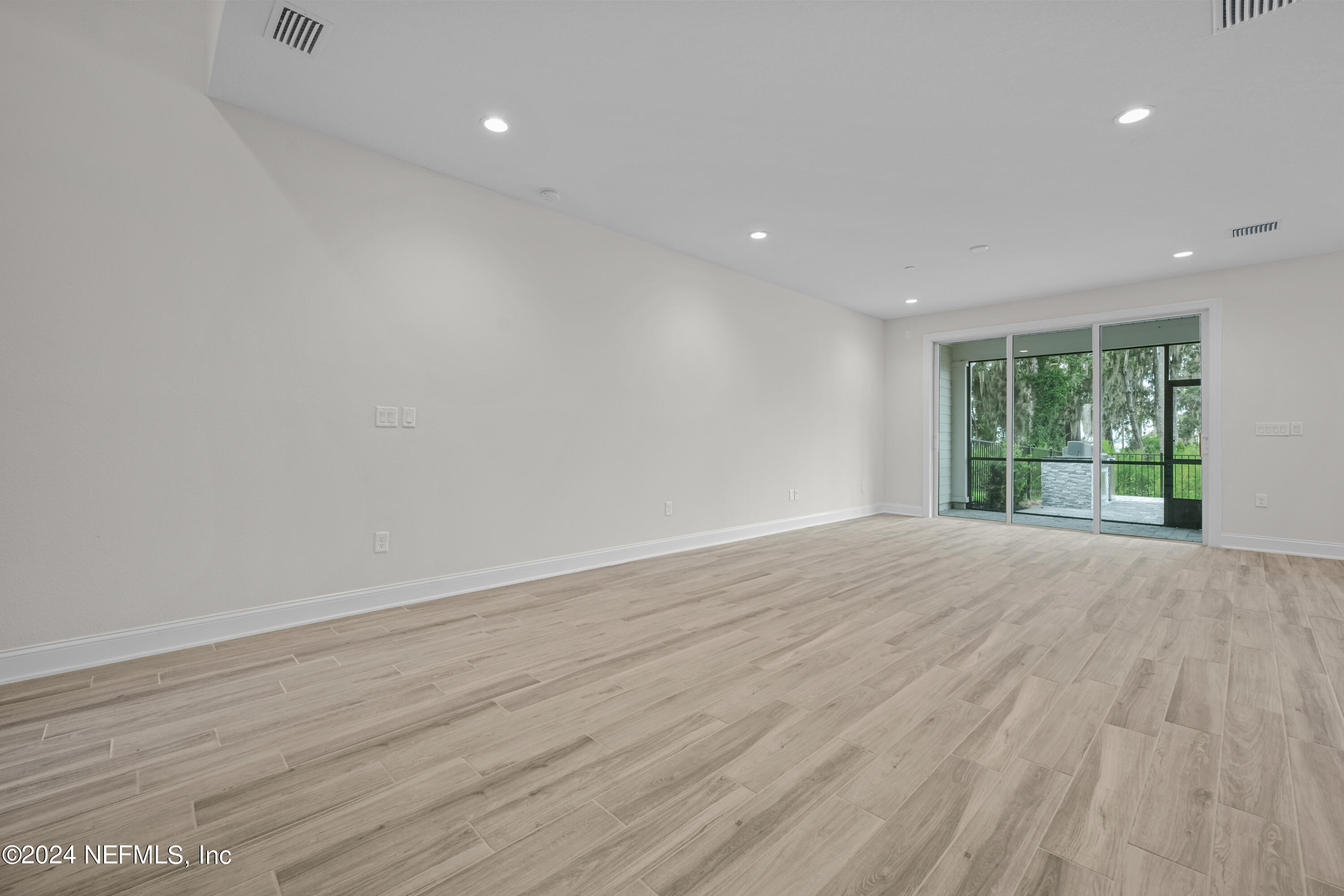 23 Oak Pk Drive St. Johns, FL 32259 - Photo 10 of 72 a view of an empty room with wooden floor and a window