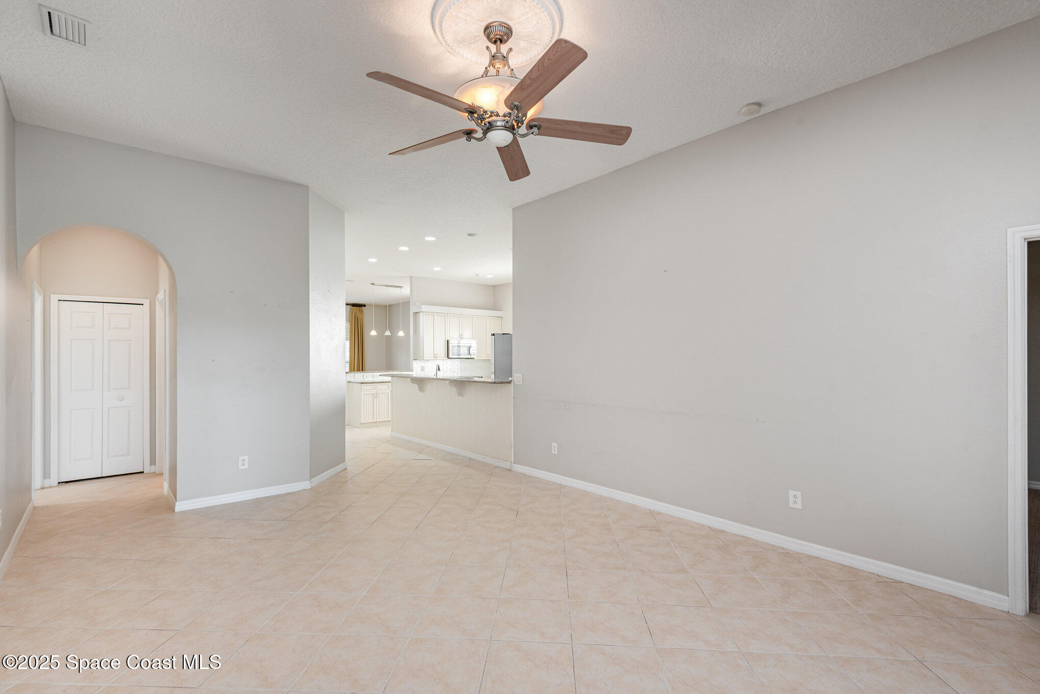 1247 Hasley Place Melbourne, FL 32940 - Photo 11 of 33 en empty room with ceiling fan and window