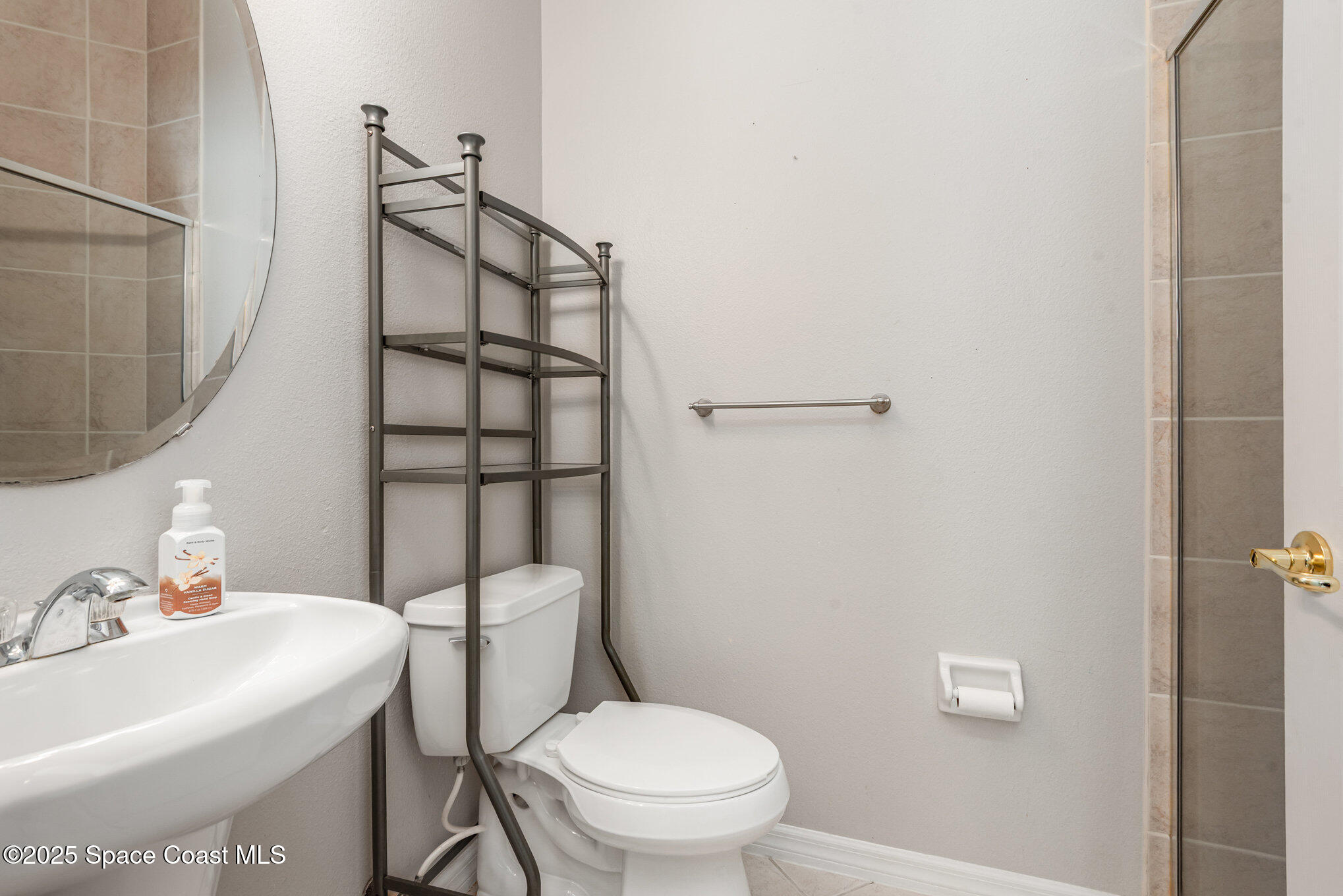 1247 Hasley Place Melbourne, FL 32940 - Photo 14 of 33 a bathroom with a sink a toilet and shower