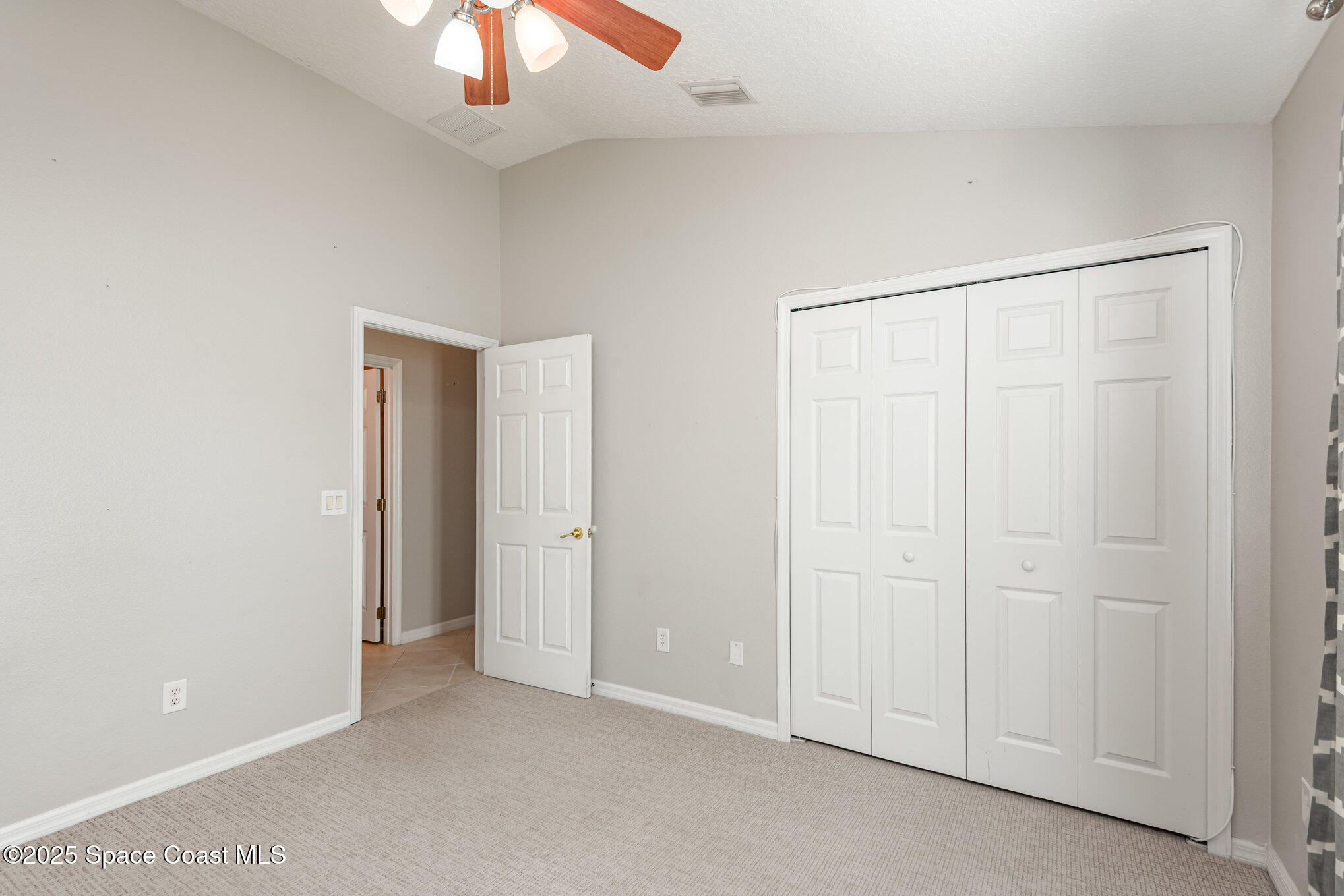 1247 Hasley Place Melbourne, FL 32940 - Photo 19 of 33 an empty room with a chandelier fan