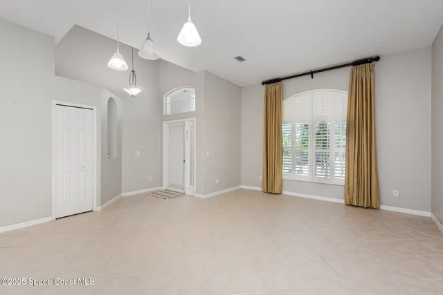 a view of an empty room with glass door
