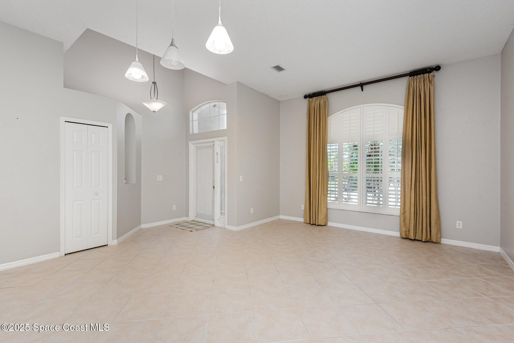 1247 Hasley Place Melbourne, FL 32940 - Photo 4 of 33 a view of an empty room with glass door