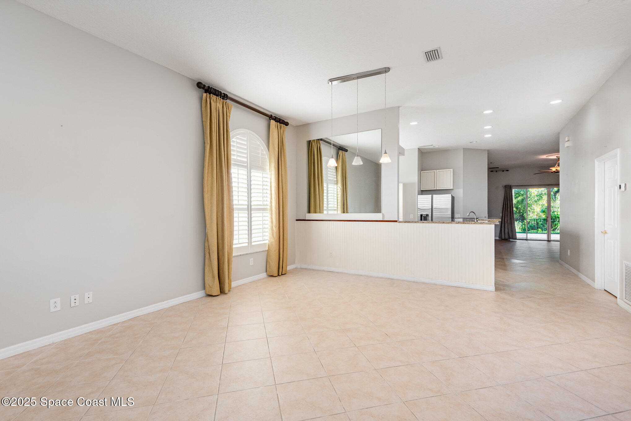 1247 Hasley Place Melbourne, FL 32940 - Photo 5 of 33 an empty room with wooden floor and windows