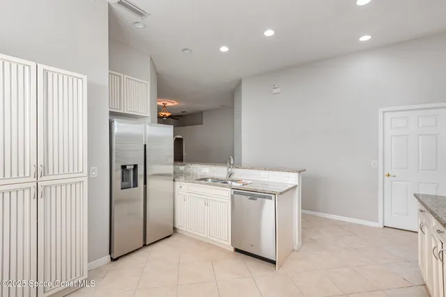a kitchen with a sink and refrigerator