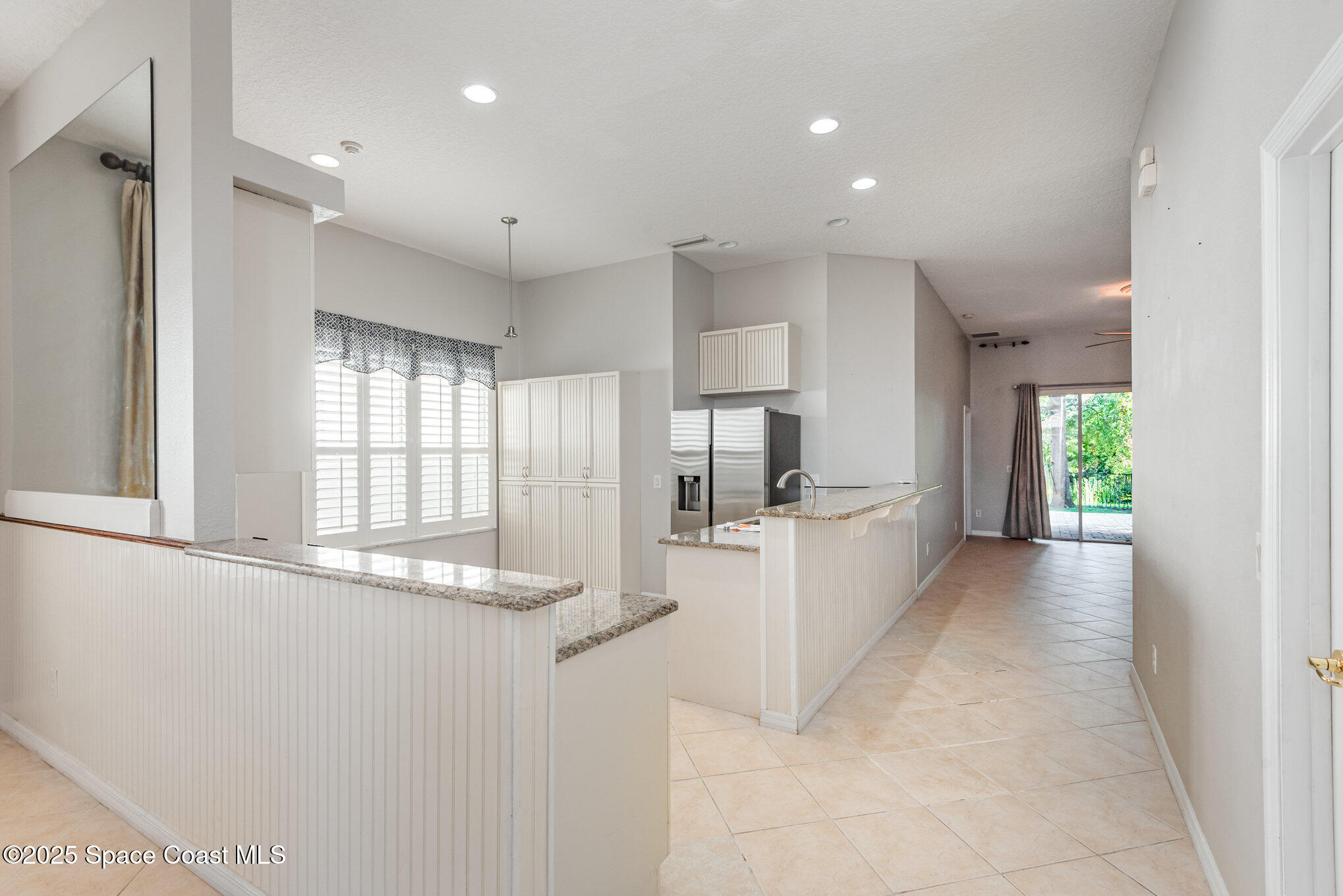 1247 Hasley Place Melbourne, FL 32940 - Photo 9 of 33 a view of kitchen with refrigerator and window