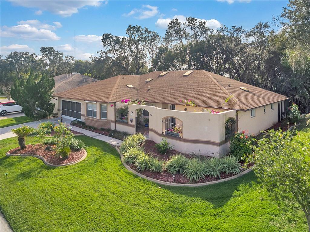 27312 Racquet Circle Leesburg, FL 34748 - Photo 1 of 1 Spacious. custom designed home, with single owners. Enjoy a welcoming front porch, full of flowers and light.